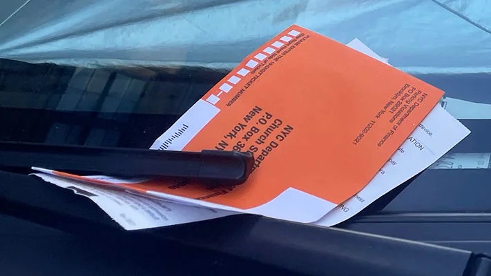 A parking ticket left on the windshield
